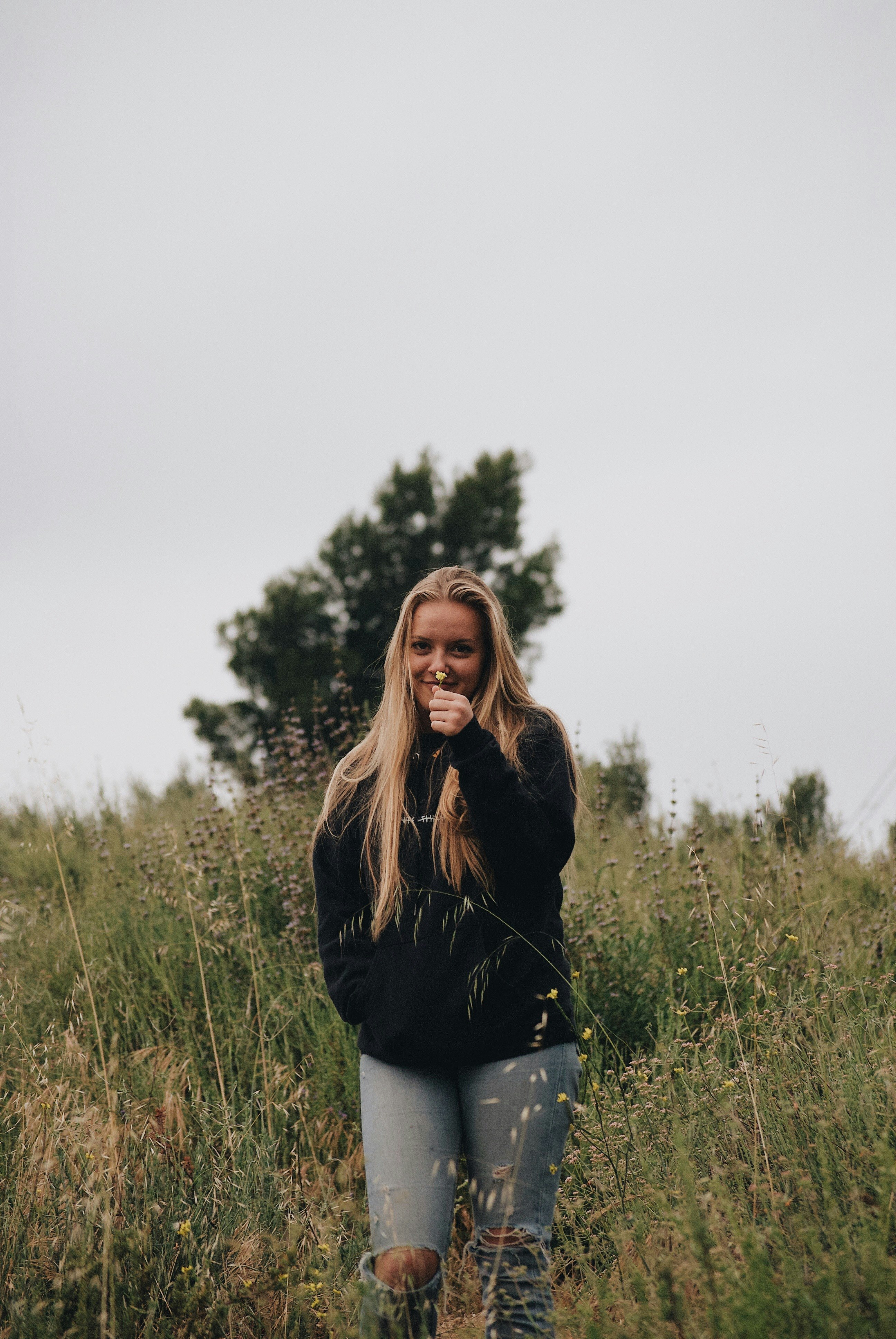 woman in black and blue in a grassy field